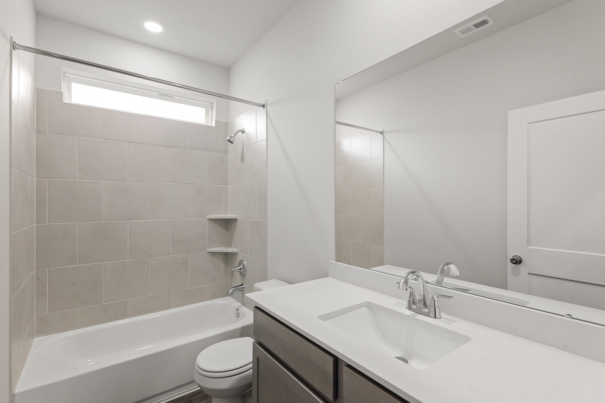 A bathroom with a tub sink and toilet.