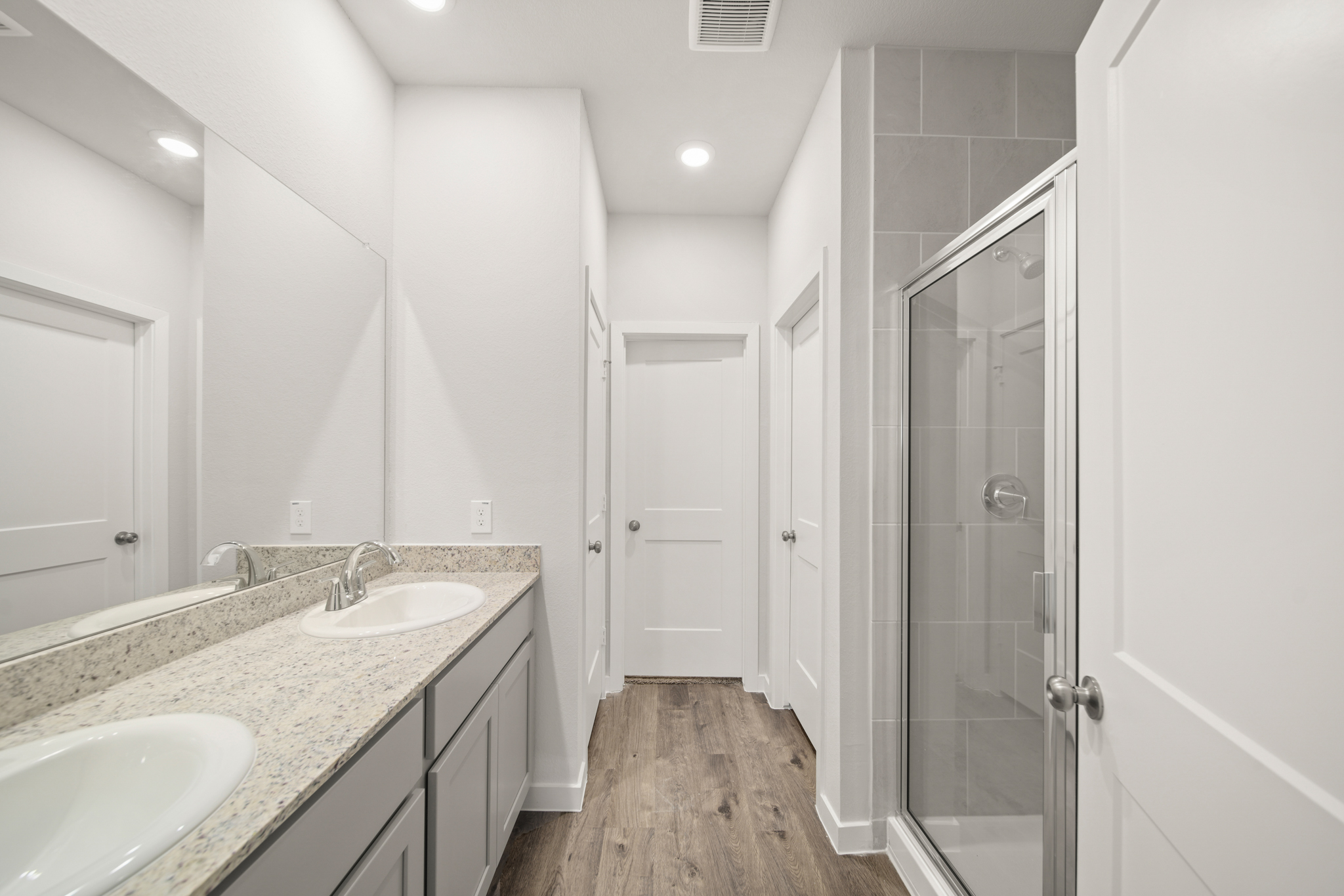 A bathroom with a sink and a shower.