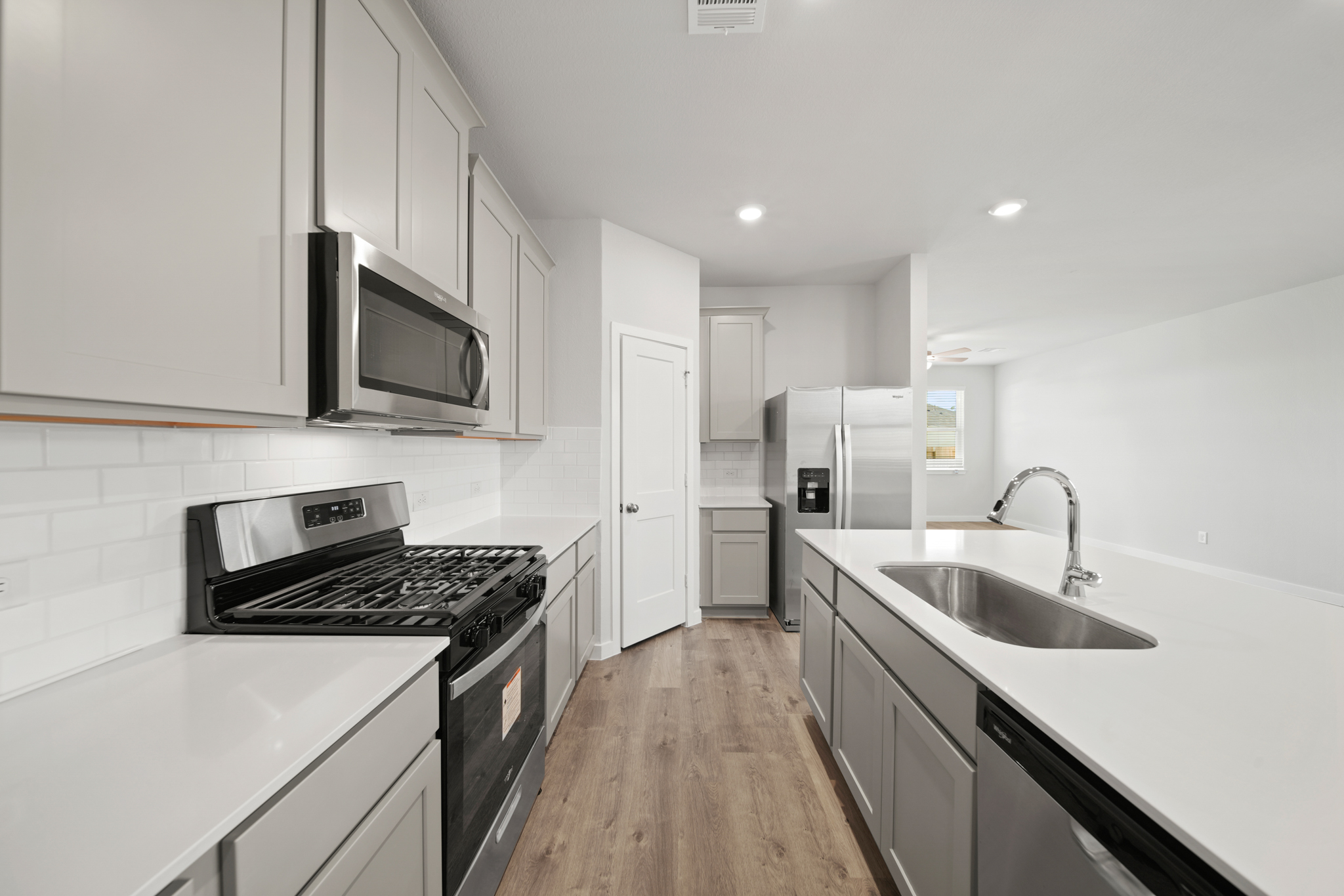 A kitchen with white cabinets.