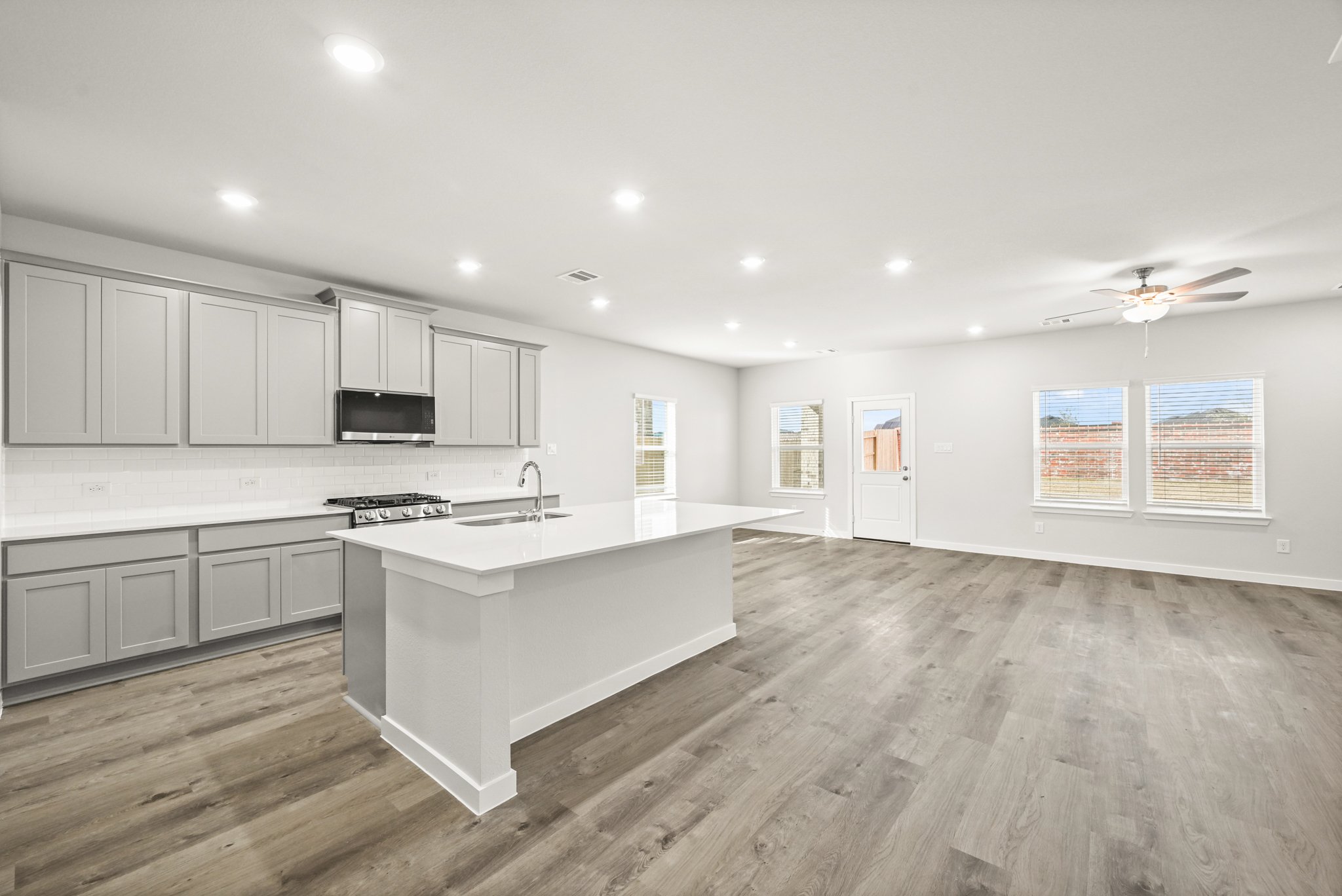 A kitchen with white cabinets.