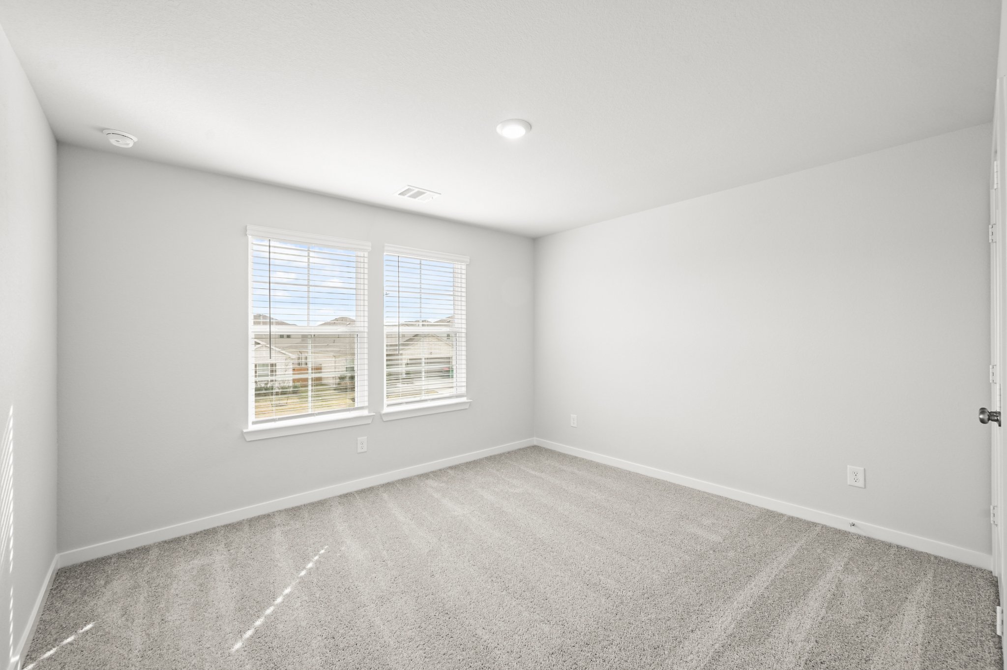 A room with a window and a carpet.