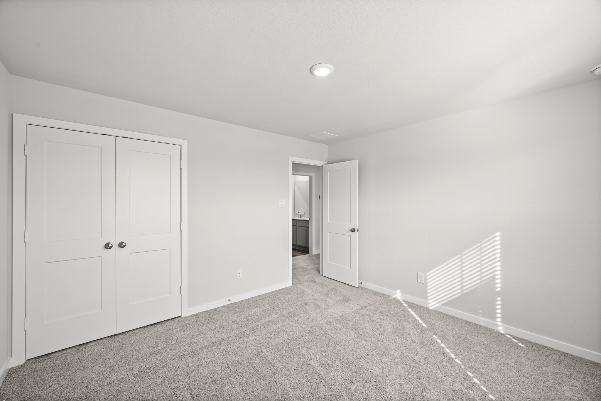 A hallway with white doors.