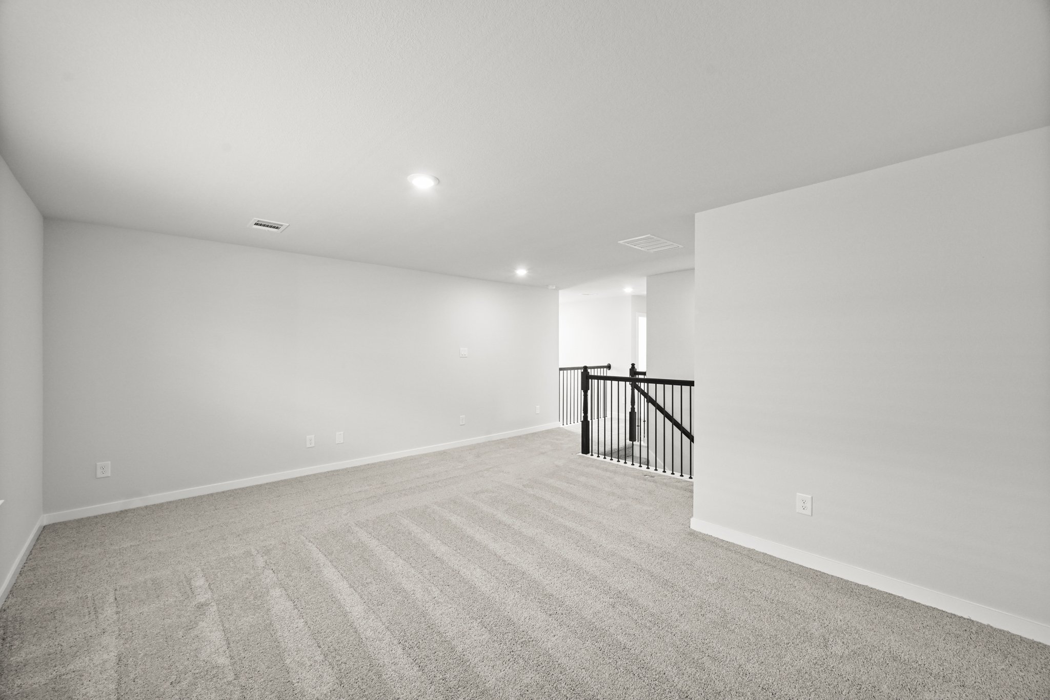 A hallway with a railing.