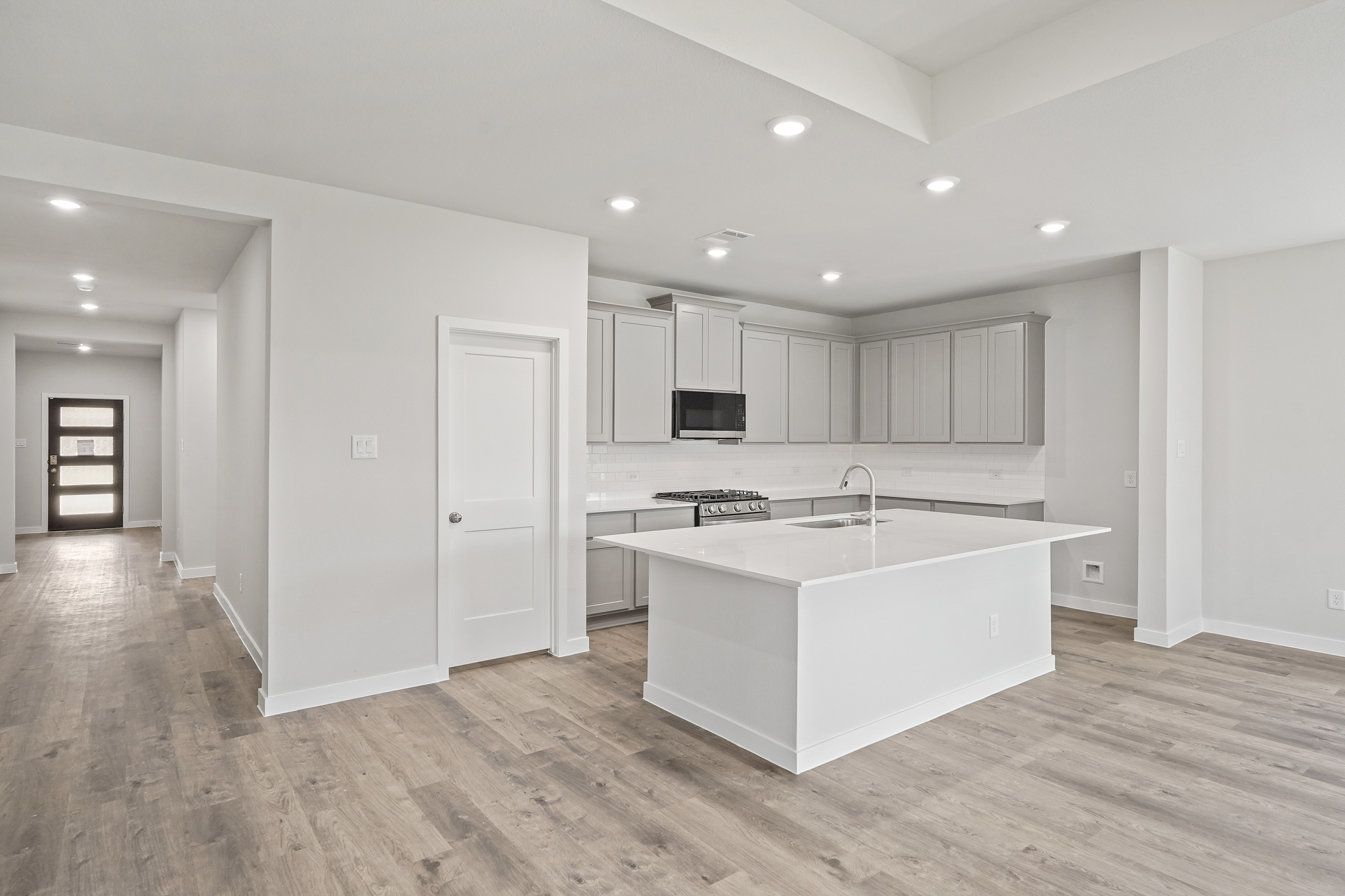 A kitchen with white cabinets.