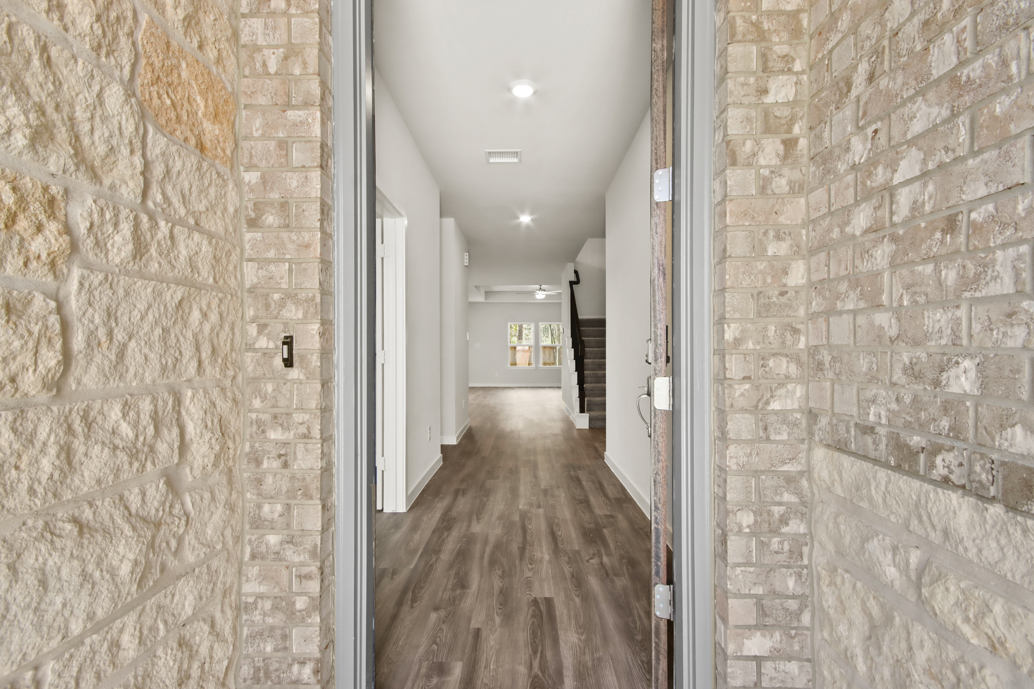A long hallway with stone walls.