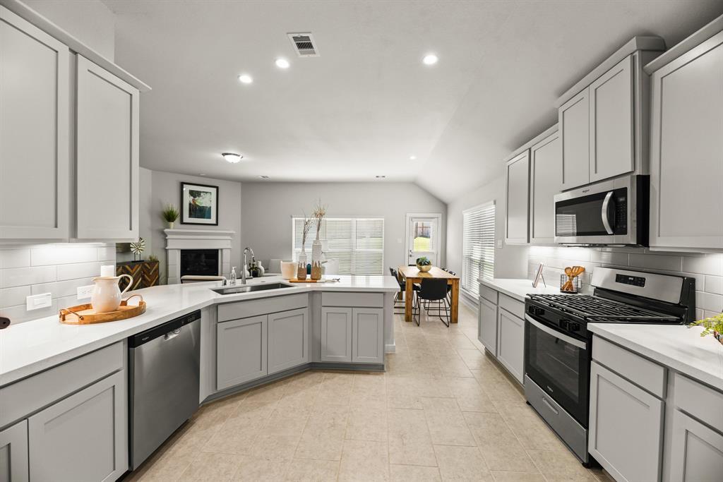 A kitchen with white cabinets.