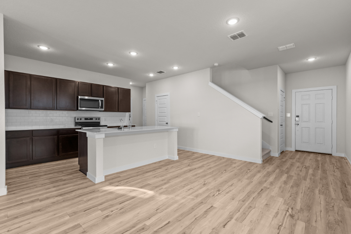 A kitchen with wooden floors.
