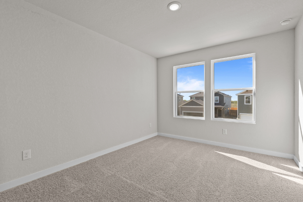A room with a window and a carpet.