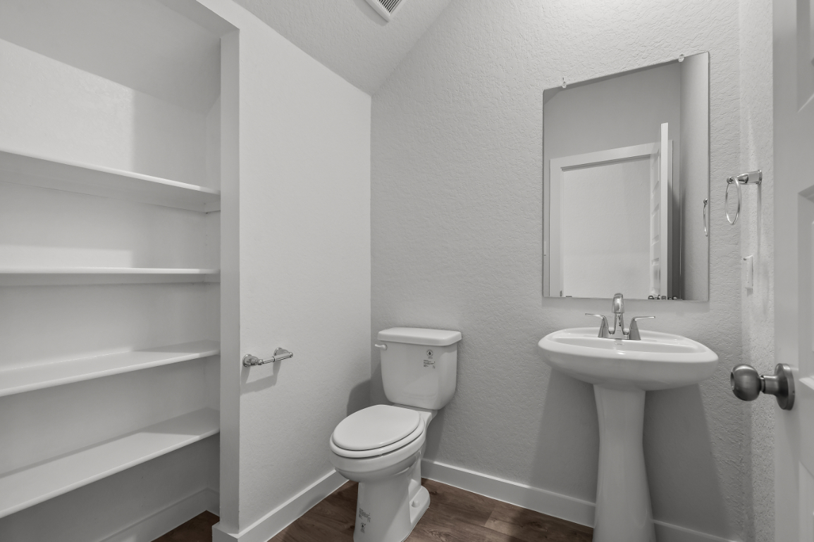 A bathroom with a toilet and sink.