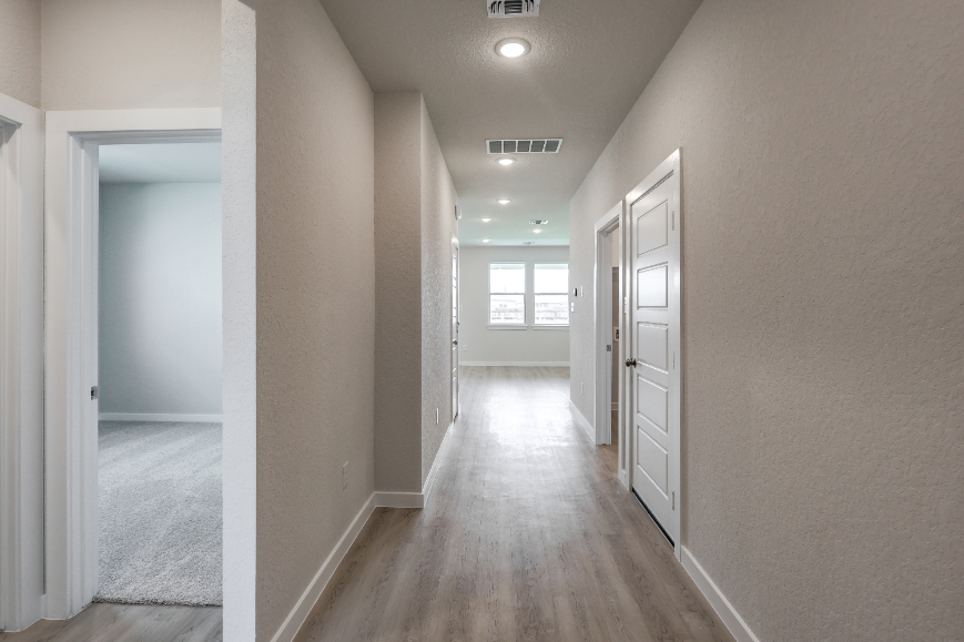 A hallway with white doors.