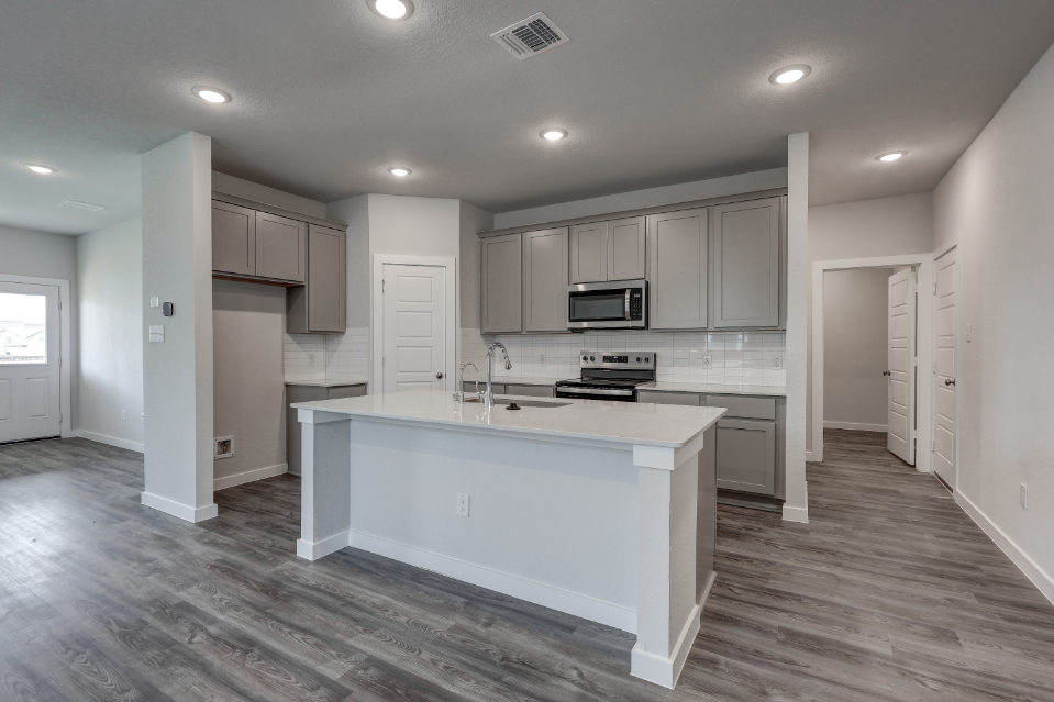A kitchen with white cabinets.