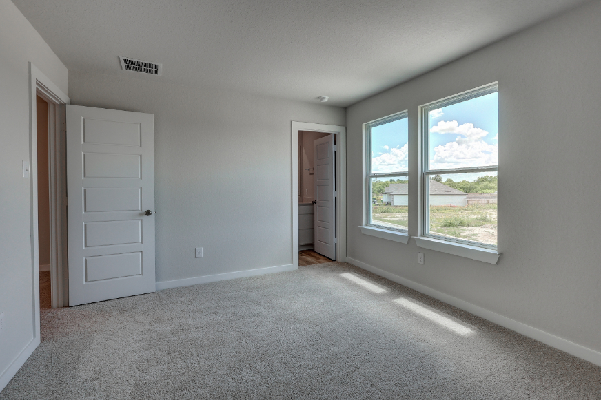 A room with white walls and a window.