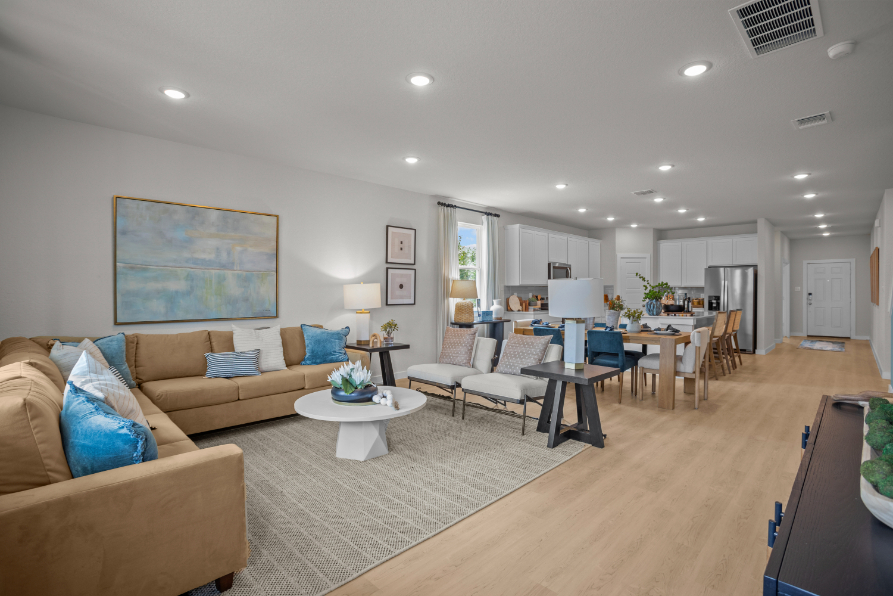 A living room with a large rug and a table.