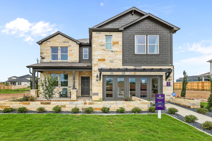 A house with a lawn in front.