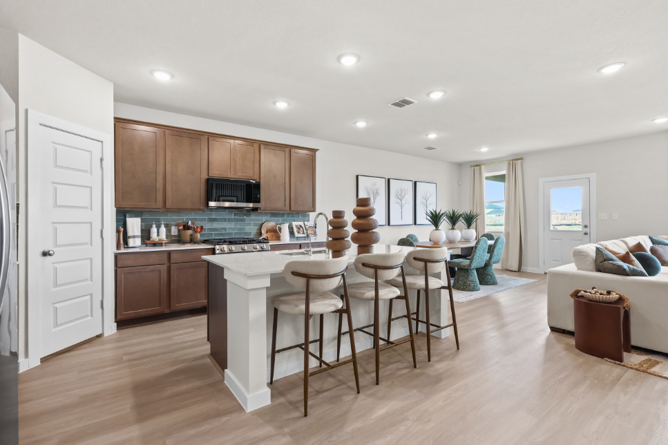 A kitchen with a dining table and chairs.