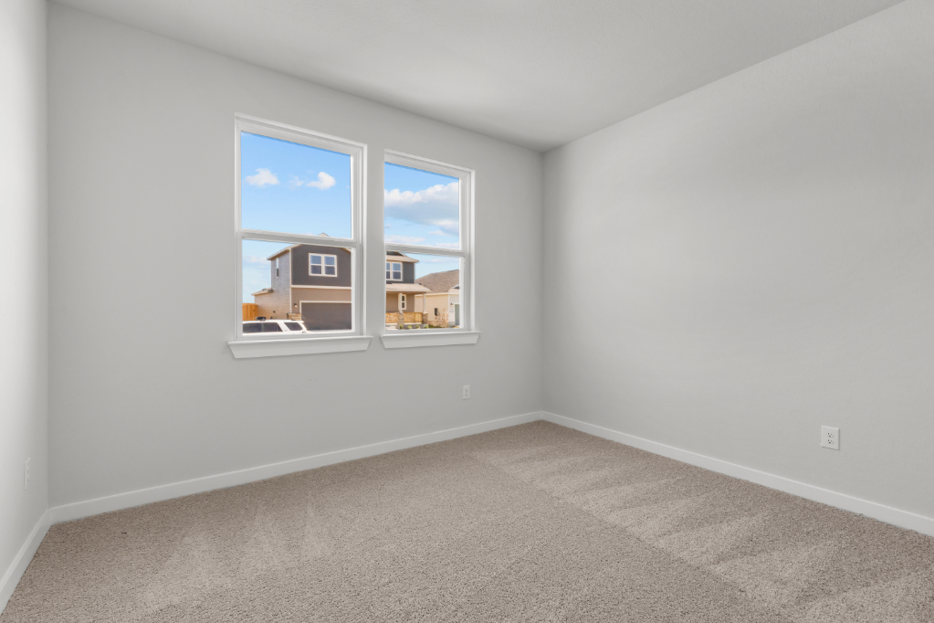 A room with a window and a carpet.