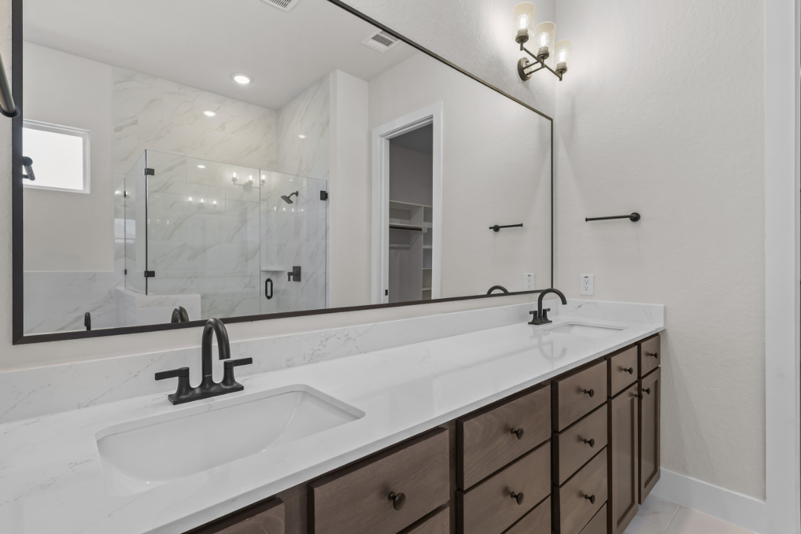 A bathroom with a large mirror.