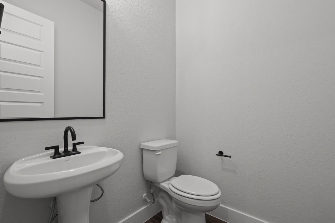 A bathroom with a toilet and sink.