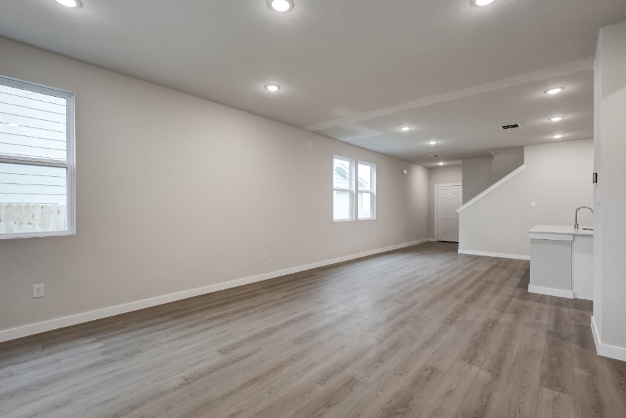 A room with a wood floor and a sink.