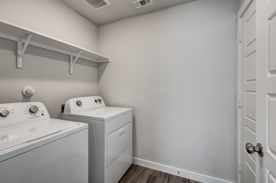 A white room with a washing machine.