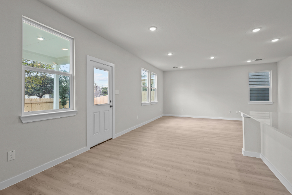 A room with a wood floor and white walls.