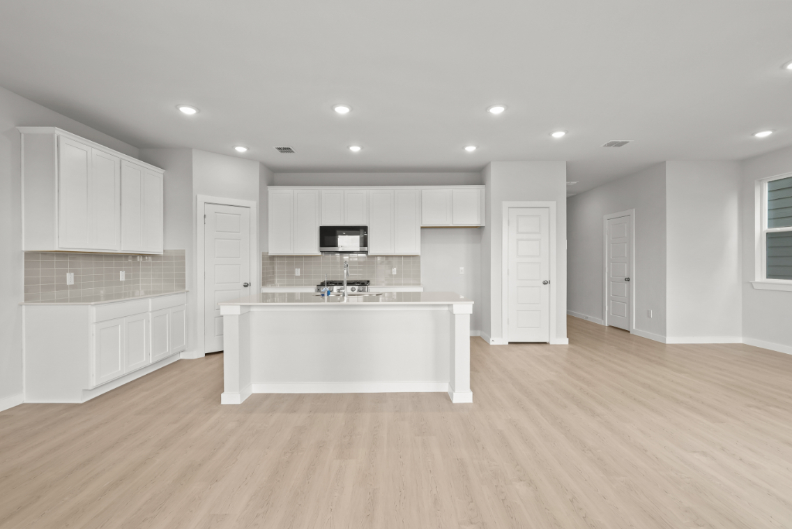 A large kitchen with white cabinets.