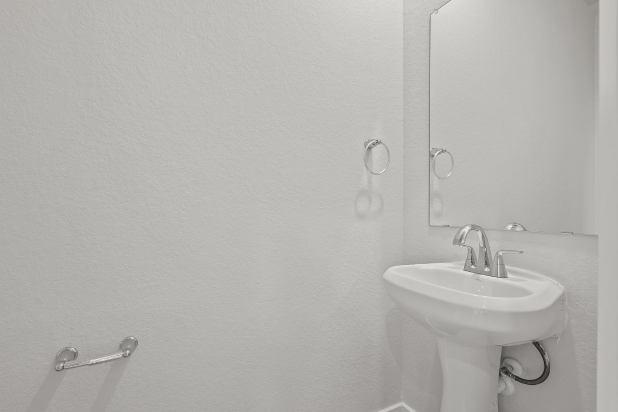 A bathroom with a sink and mirror.