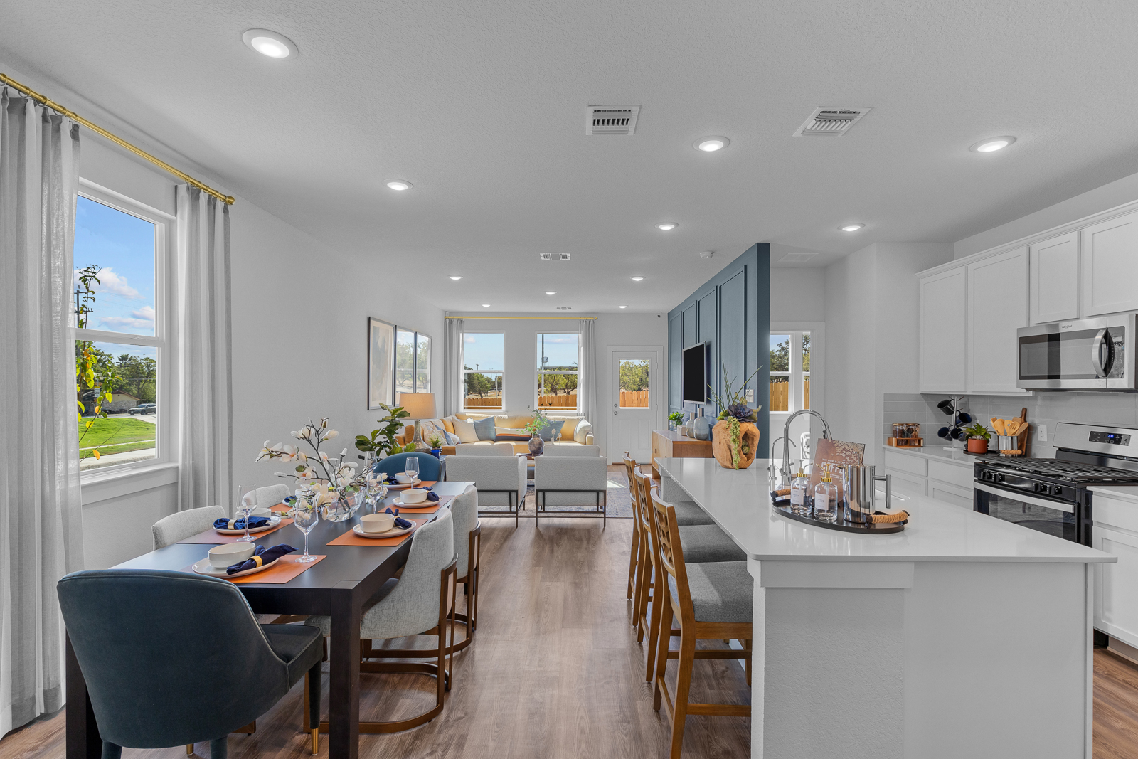 A kitchen with a dining table and chairs.