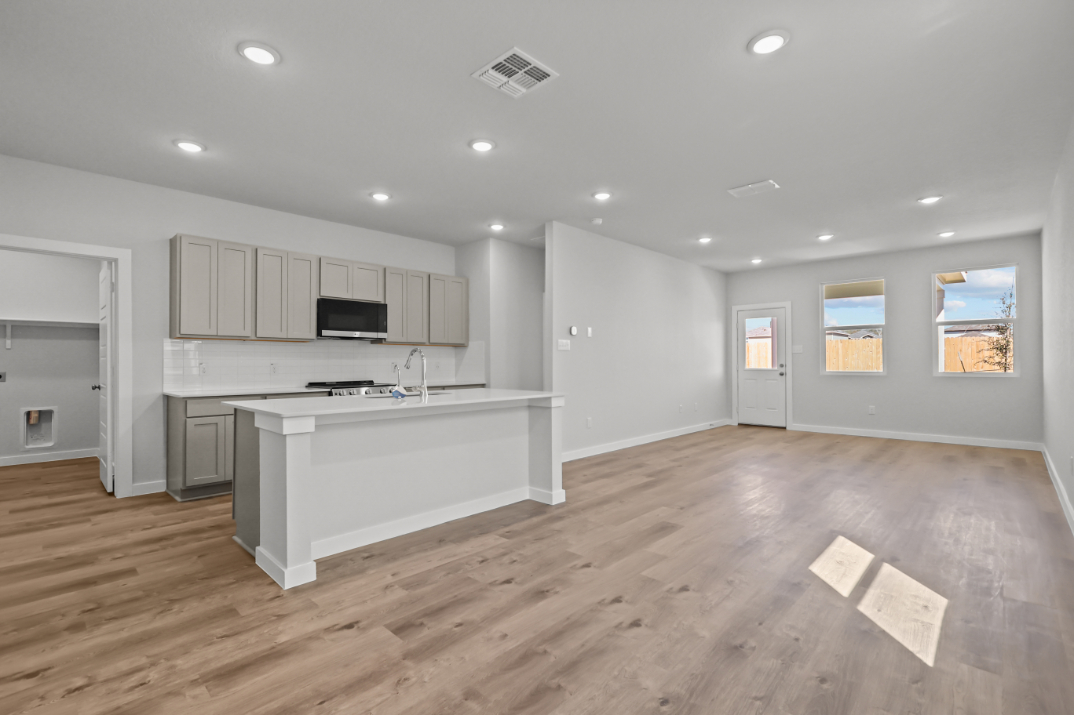 A large kitchen with white cabinets.