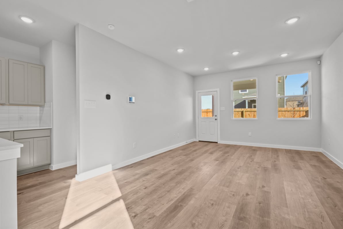 A room with white walls and a wood floor.