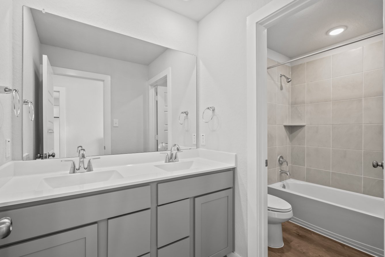 A bathroom with a tub sink and toilet.
