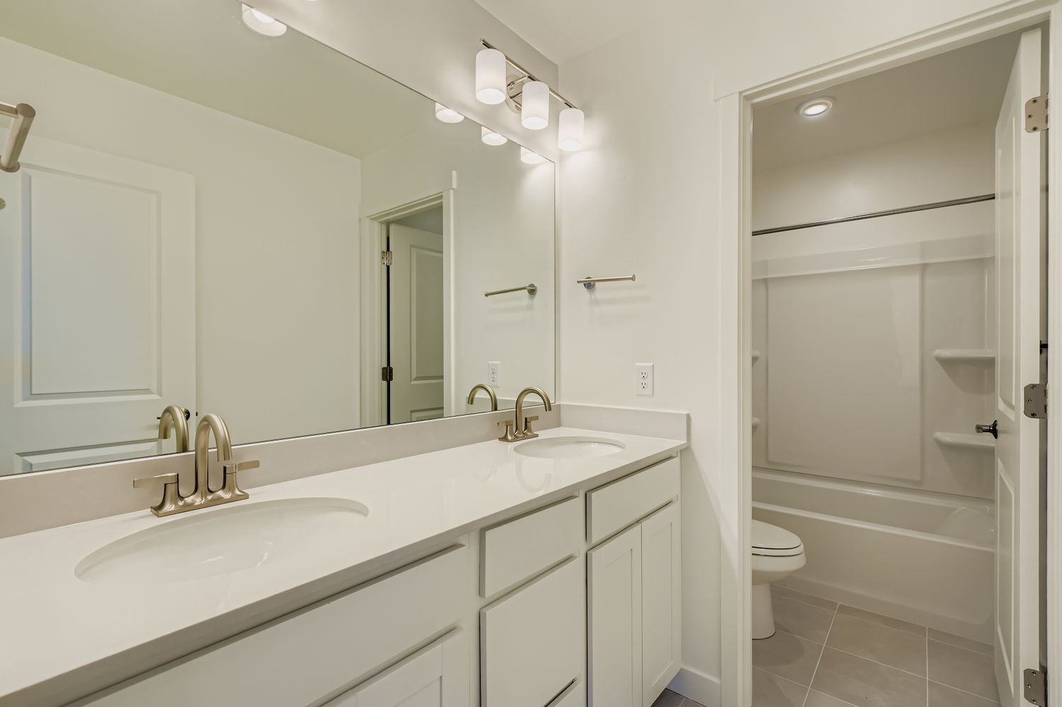 A bathroom with a sink toilet and shower.