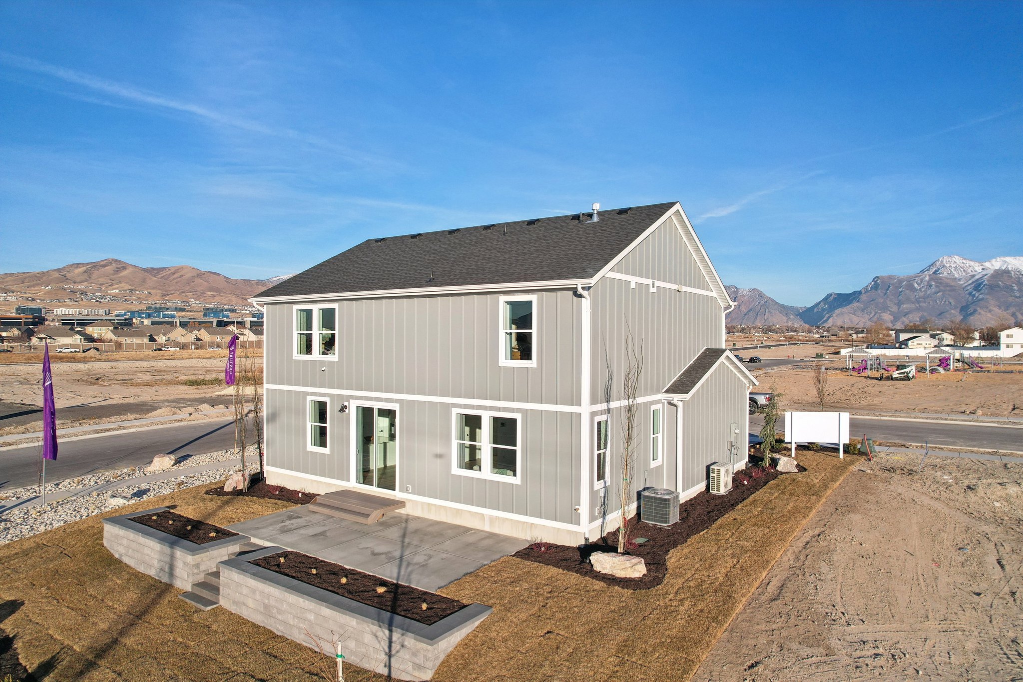 A white house in a dirt field.