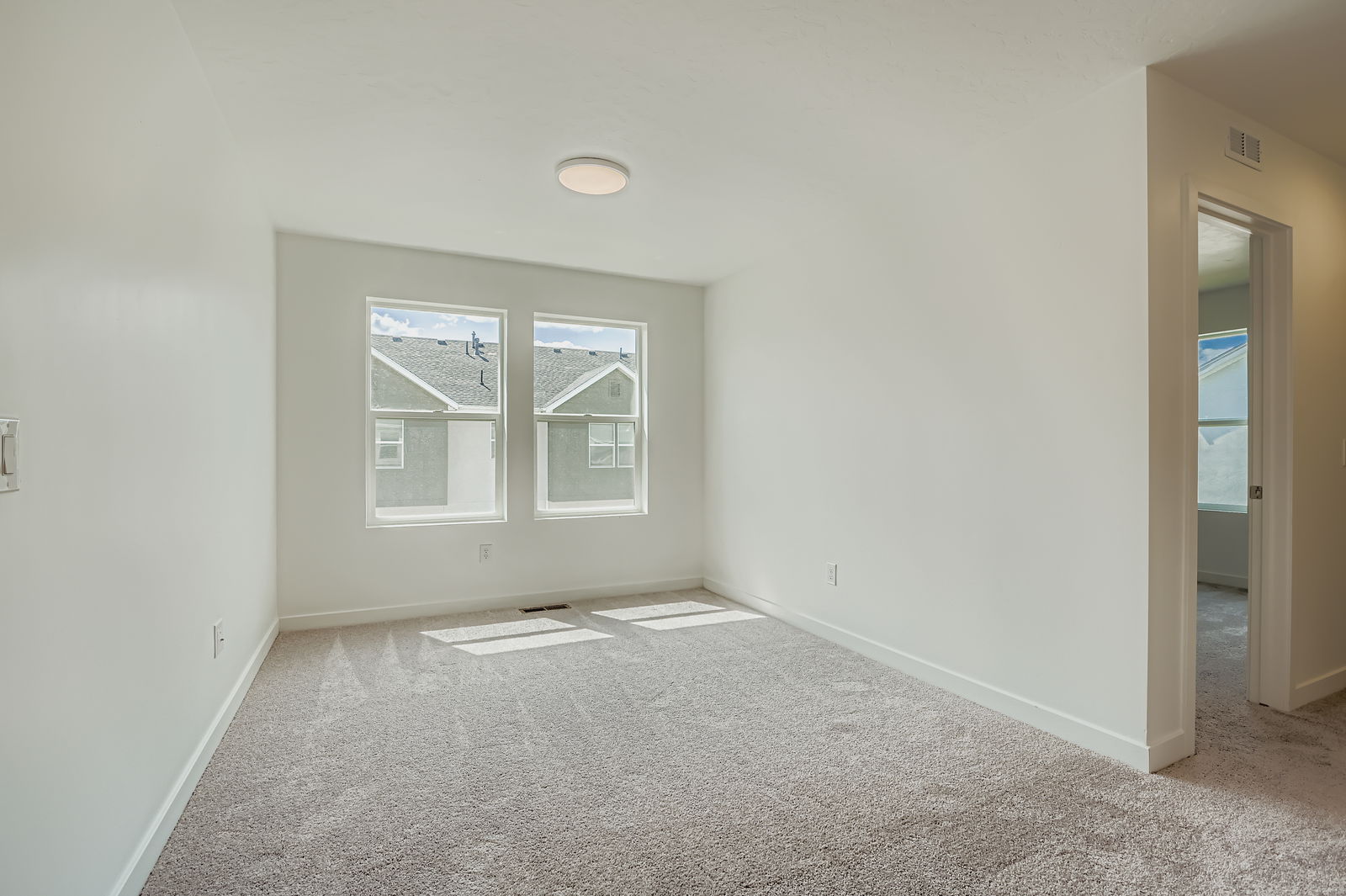 A room with a window and a carpet.