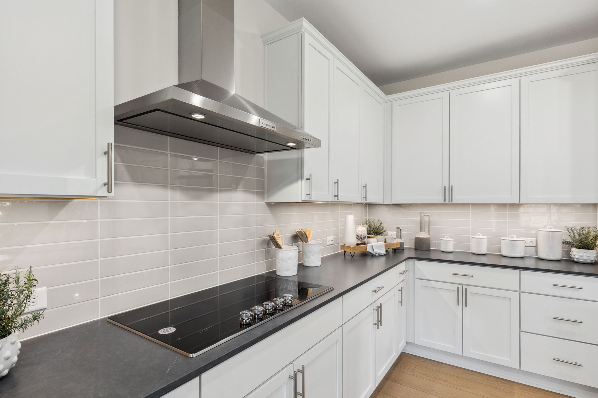 A kitchen with white cabinets.