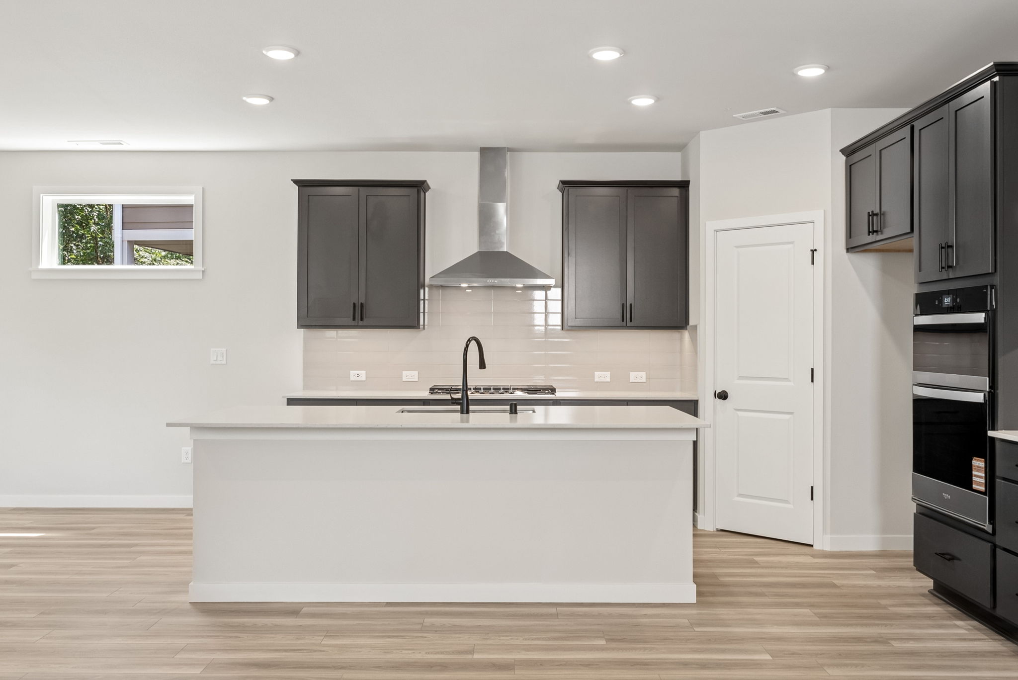 A kitchen with black cabinets.