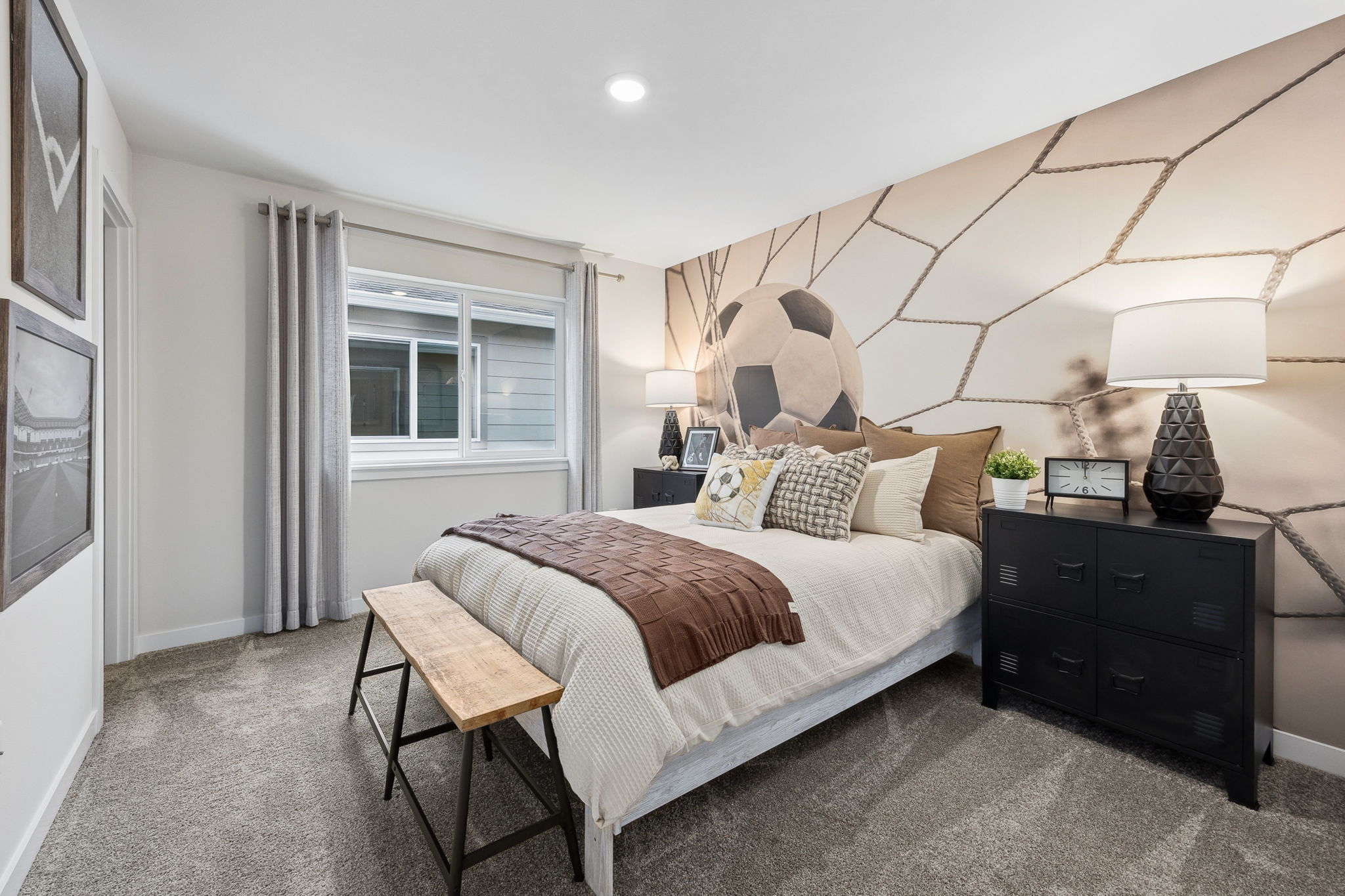 A bedroom with a bed and a table.