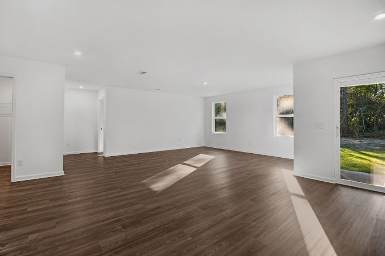 A room with a wood floor and white walls.