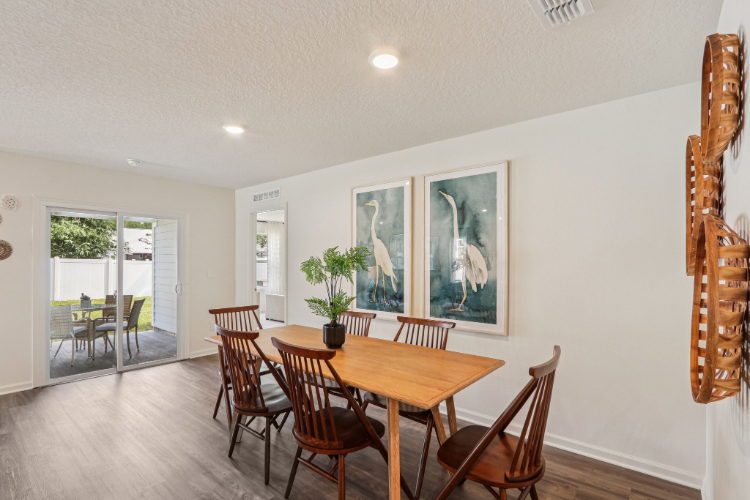 A dining room with a table and chairs.