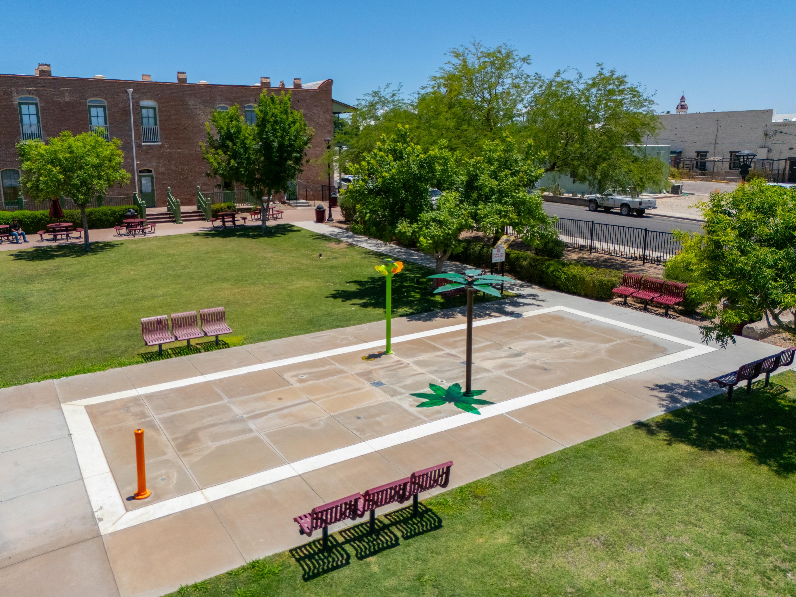 A courtyard with benches and trees.