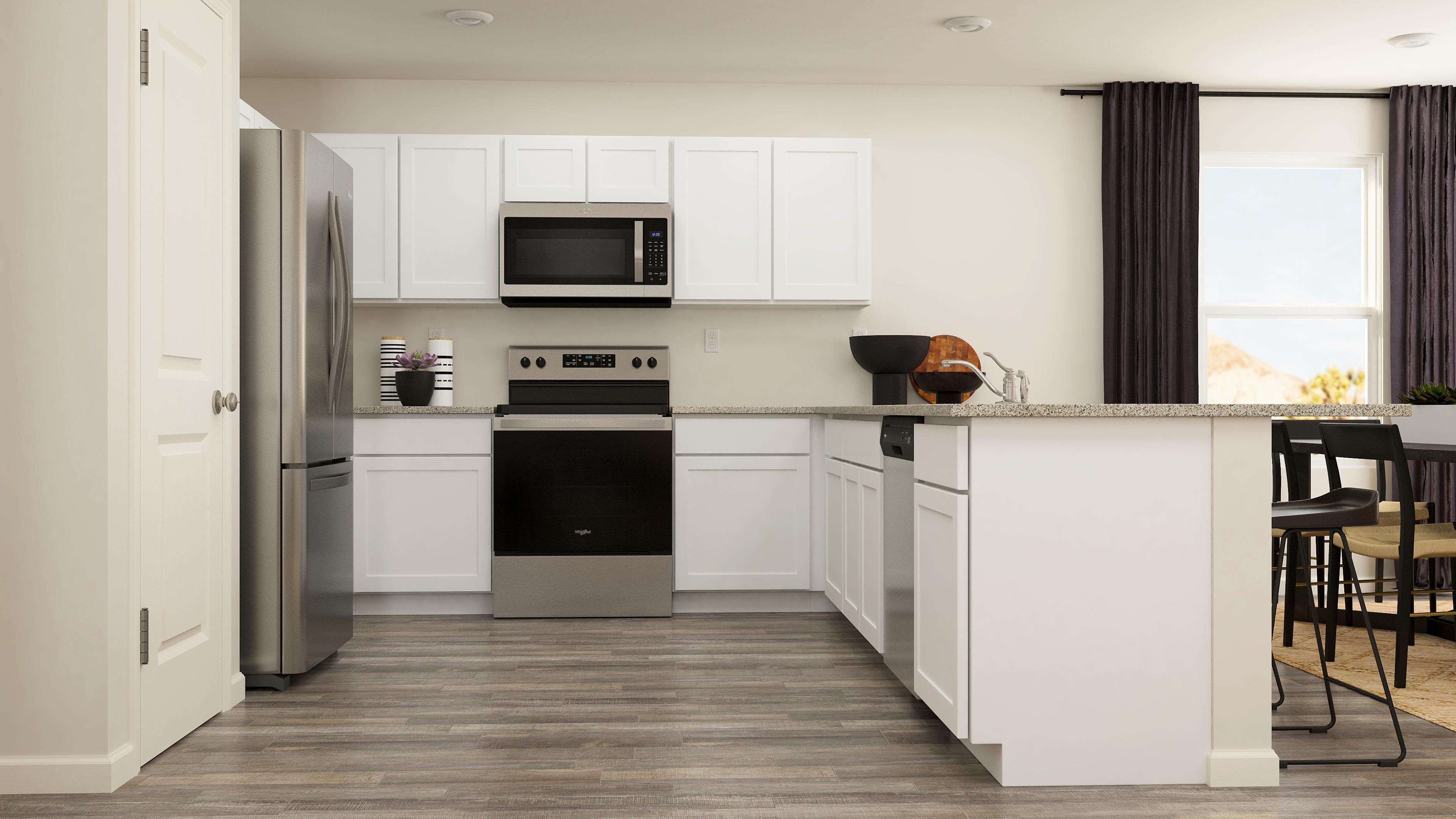 A kitchen with white cabinets.