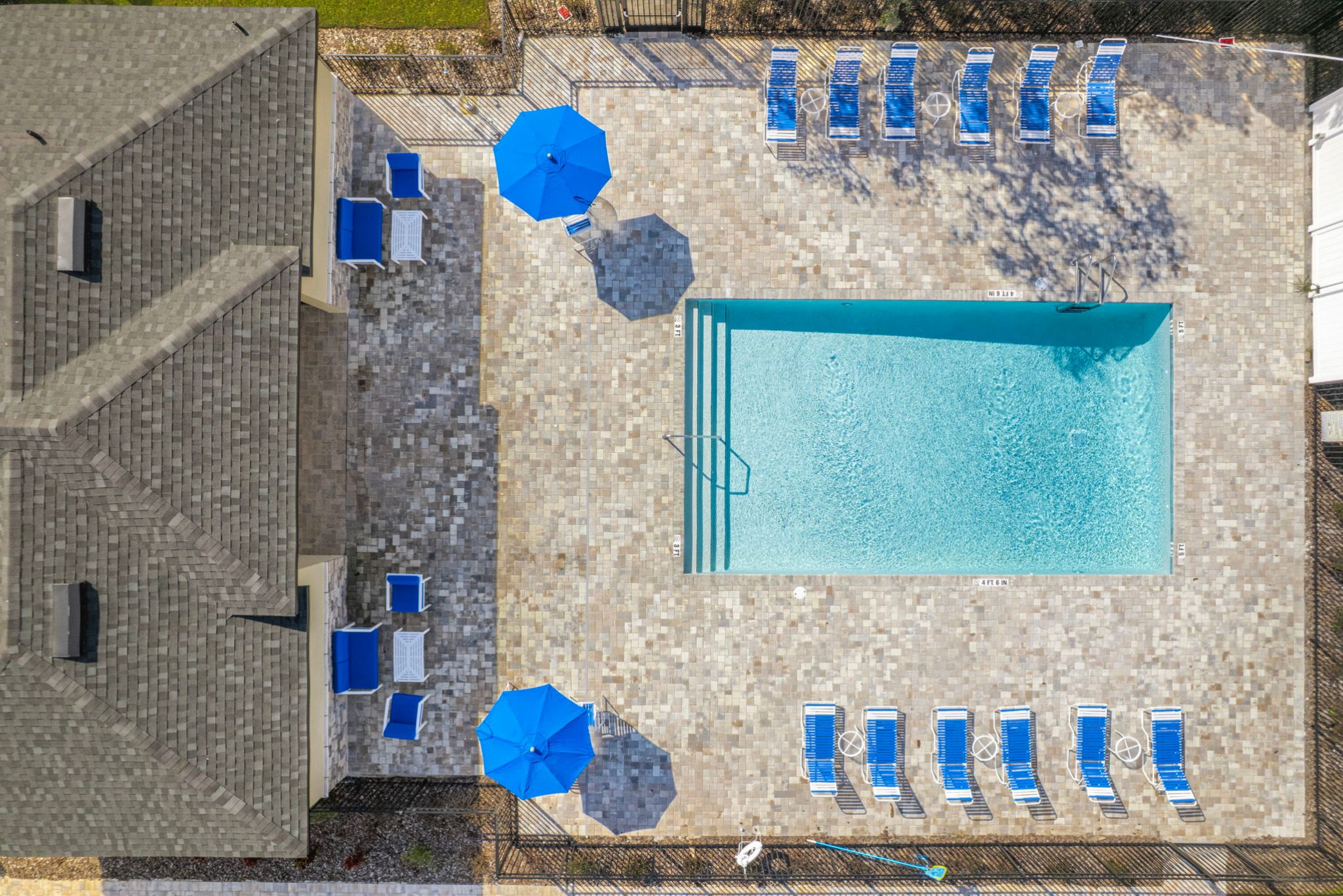 A stone building with blue umbrellas.