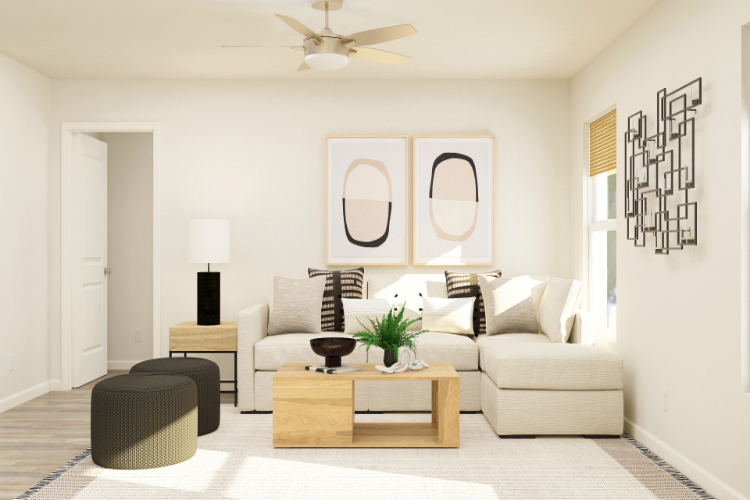 A living room with a white couch and a white ceiling fan.