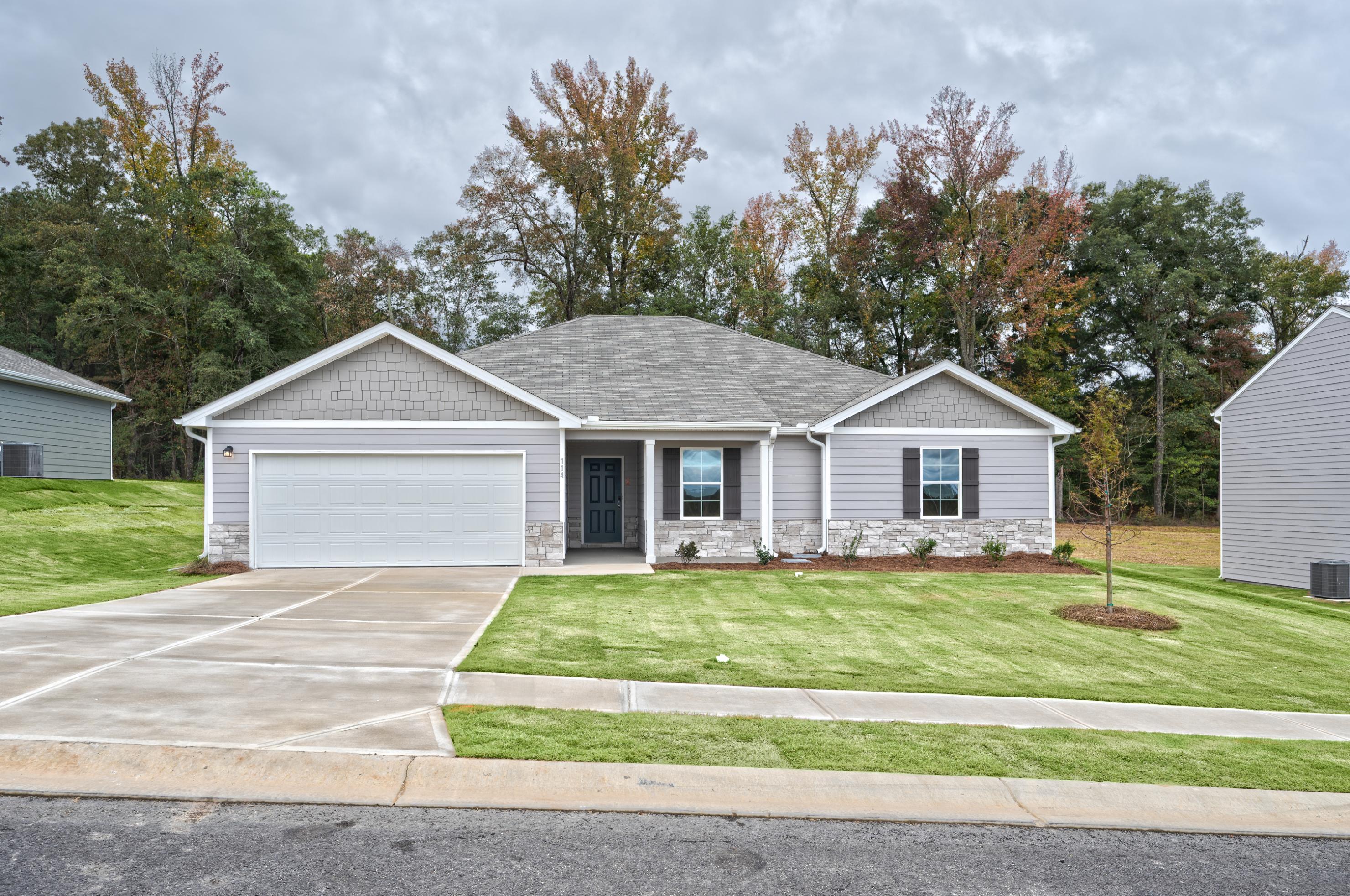 A white house with a garage.