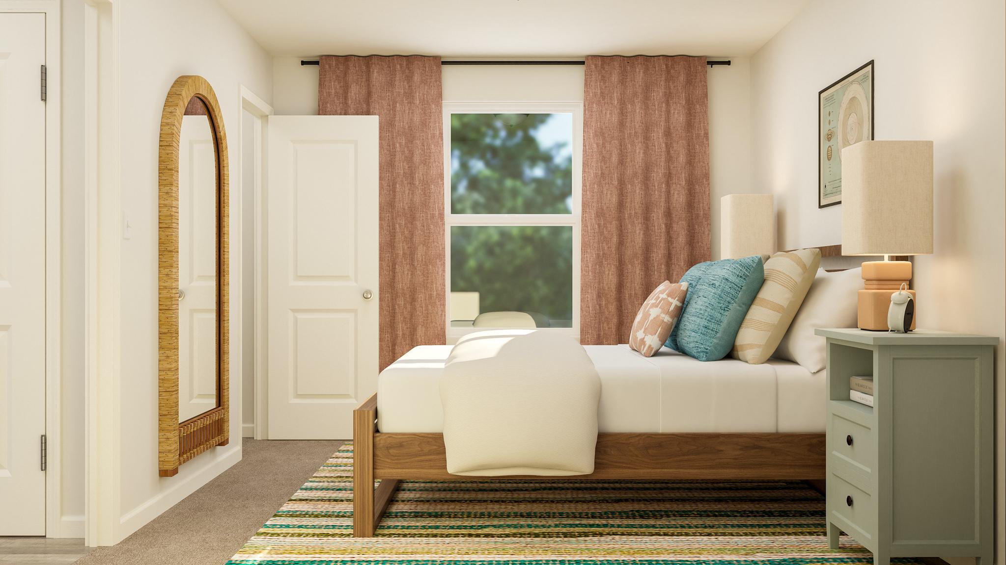 A bedroom with a bed and a mirror.