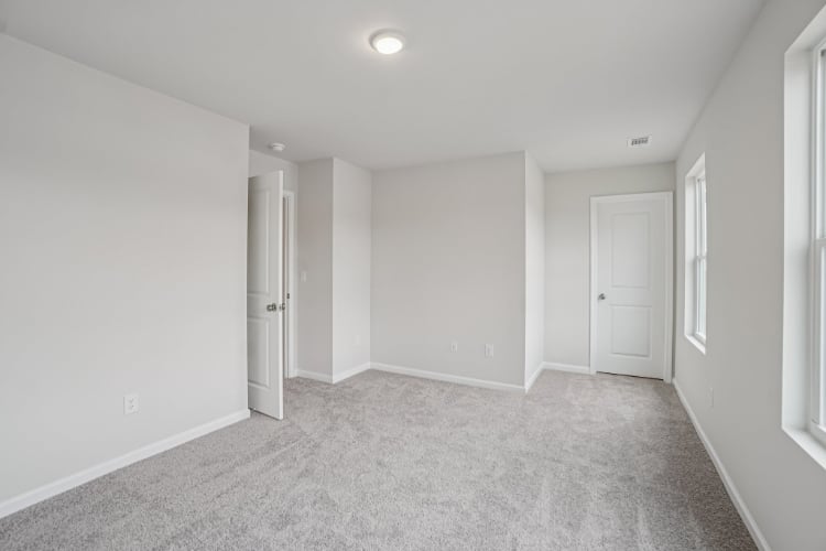 A hallway with white doors.