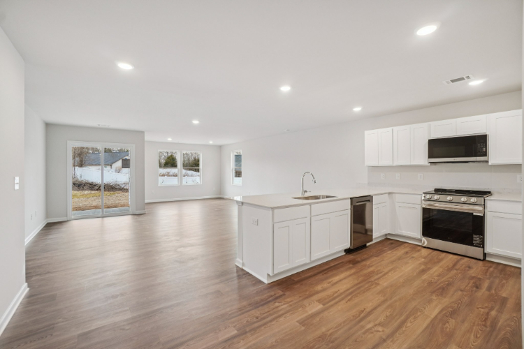 A kitchen with white cabinets.