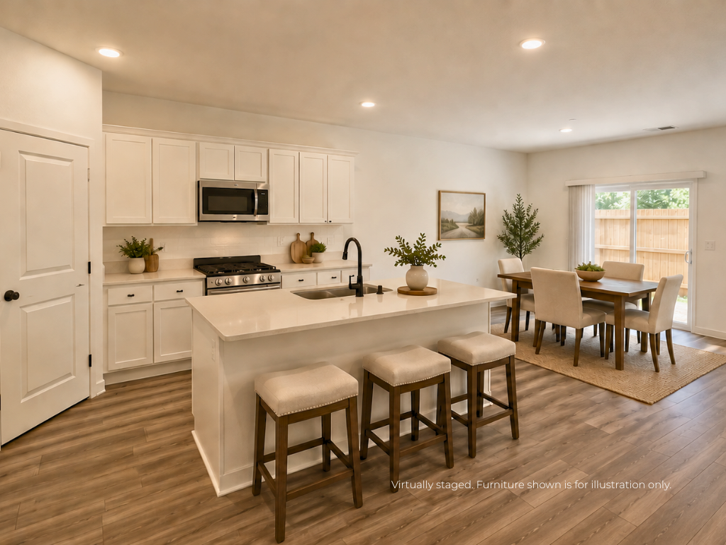 A kitchen with a table and chairs.