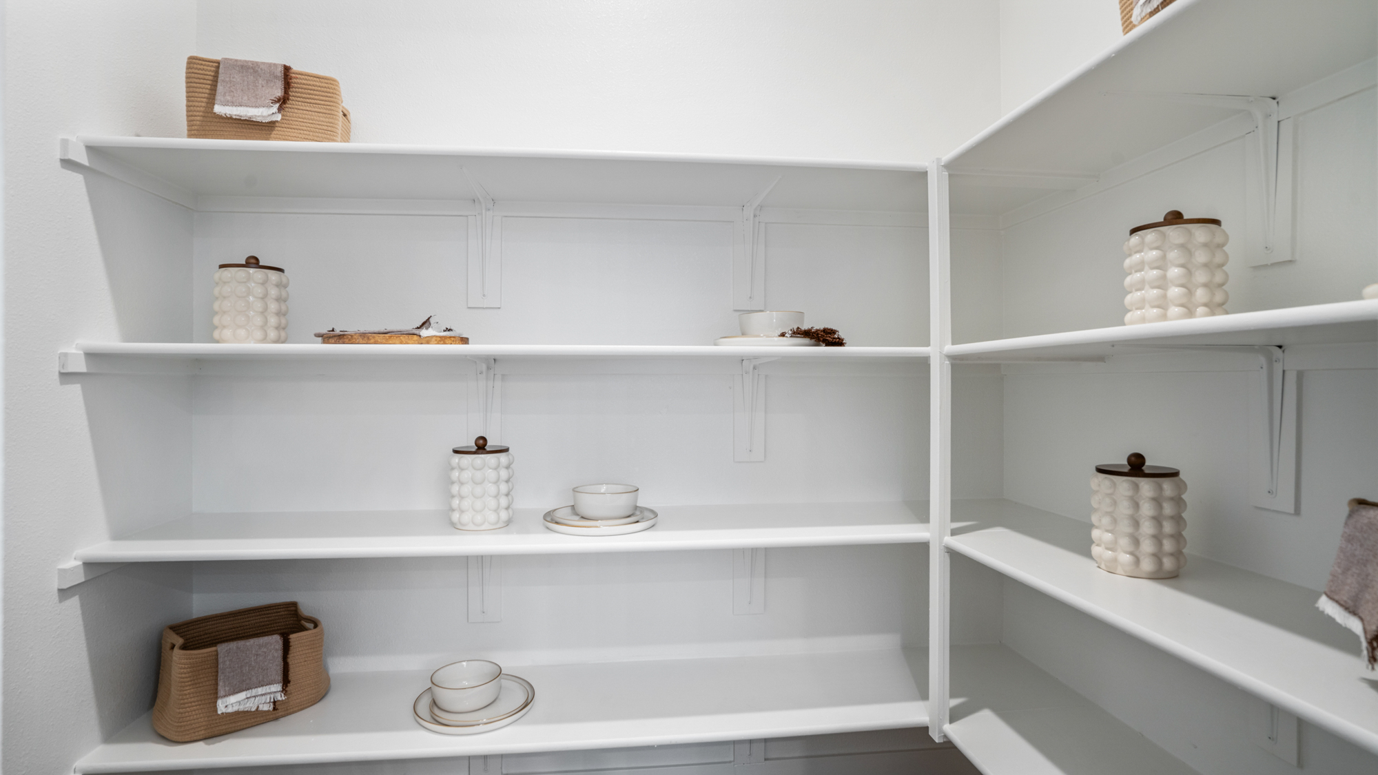 A white shelving unit with white shelves and white shelves.